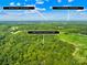 Aerial view shows the proximity of the property to nearby communities and highlights the natural surroundings at 32060A Flint Ridge Rd, Albemarle, NC 28001
