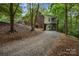 Brick home exterior featuring lush landscaping, and boat storage beneath the home at 32060A Flint Ridge Rd, Albemarle, NC 28001