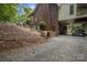Landscaped backyard of a home featuring brick construction and boat storage under the home at 32060A Flint Ridge Rd, Albemarle, NC 28001