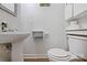 Clean half bath with a pedestal sink, toilet, and built-in storage for toiletries and essentials at 32060A Flint Ridge Rd, Albemarle, NC 28001