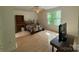 Bedroom with wood floors, an area rug, and large windows provides ample natural light at 32060A Flint Ridge Rd, Albemarle, NC 28001