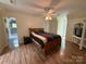 Bright bedroom with wood flooring, ceiling fan, ensuite bathroom, and window offering natural light at 32060A Flint Ridge Rd, Albemarle, NC 28001