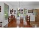 Bright dining room featuring a large wood table with decorative shelving on the walls and natural light at 32060A Flint Ridge Rd, Albemarle, NC 28001