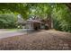 Backyard view with a carport, a pool, a brick house, and a covered porch with seating at 32060A Flint Ridge Rd, Albemarle, NC 28001