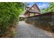 Garage exterior featuring brick construction, boat storage, and long driveway at 32060A Flint Ridge Rd, Albemarle, NC 28001