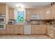 Kitchen featuring wood cabinets, tiled flooring, and stainless-steel appliances, with a unique deer-themed window at 32060A Flint Ridge Rd, Albemarle, NC 28001