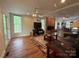 Spacious living room with a fireplace, hardwood floors, large windows, and a ceiling fan at 32060A Flint Ridge Rd, Albemarle, NC 28001