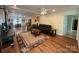 Open-concept living area with wood floors, a comfortable seating arrangement, and seamless flow to the dining at 32060A Flint Ridge Rd, Albemarle, NC 28001
