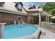 Relaxing backyard pool featuring brick accents, a covered patio, and a serene outdoor space at 32060A Flint Ridge Rd, Albemarle, NC 28001