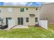 Home backyard with concrete patio, privacy fence, air conditioning unit and sliding glass doors at 3832 Amalia Pl, Indian Land, SC 29707