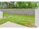 A well-maintained backyard has healthy green grass and a concrete retaining wall at 3832 Amalia Pl, Indian Land, SC 29707
