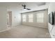 Bedroom with carpet, a ceiling fan, three windows with blinds, and a wall-mounted TV at 3832 Amalia Pl, Indian Land, SC 29707