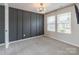 Bright bedroom with paneled accent wall, recessed lighting, and windows at 3832 Amalia Pl, Indian Land, SC 29707