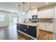 Modern kitchen with a large island, stainless steel appliances, and stylish pendant lighting at 3832 Amalia Pl, Indian Land, SC 29707