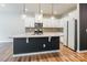 Modern kitchen featuring white cabinetry, stainless steel appliances, and stylish island pendant lights at 3832 Amalia Pl, Indian Land, SC 29707