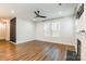 Bright living room with hardwood flooring, modern ceiling fan, and fireplace for a warm space at 3832 Amalia Pl, Indian Land, SC 29707