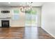 Bright living room with a fireplace, hardwood flooring, and sliding glass doors leading to the backyard at 3832 Amalia Pl, Indian Land, SC 29707