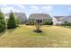 Expansive backyard with a well-manicured lawn, stone patio, and a view of neighboring houses at 4019 Channel Islands Way, Lancaster, SC 29720