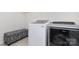 Neat laundry room with a front-loading washer and dryer, and a patterned storage bench at 4019 Channel Islands Way, Lancaster, SC 29720