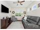 Living area features a comfortable grey leather sofa, television, and neutral walls at 4019 Channel Islands Way, Lancaster, SC 29720
