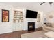 Cozy living room with a fireplace, built-in bookshelves, and hardwood floors at 4019 Channel Islands Way, Lancaster, SC 29720