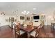 Open-concept living space with kitchen island, dining area, fireplace, and hardwood floors at 4019 Channel Islands Way, Lancaster, SC 29720