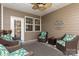 Inviting screened-in patio with wicker chairs and a ceiling fan, perfect for outdoor relaxation at 4019 Channel Islands Way, Lancaster, SC 29720