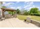 Backyard featuring a covered patio with a picnic table, BBQ, and lush green lawn at 407 Goodloe Dr, Charlotte, NC 28262