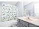 Well-lit bathroom with a tub-shower combination and stylish patterned shower curtain at 407 Goodloe Dr, Charlotte, NC 28262