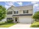 Two-story home with black shutters, fresh green lawn and a two car garage under a cloudy blue sky at 407 Goodloe Dr, Charlotte, NC 28262