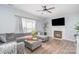 Comfortable living room with plush gray seating, modern fireplace, and elegant ceiling fan at 407 Goodloe Dr, Charlotte, NC 28262