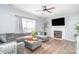 Comfortable living room with plush gray seating, modern fireplace, and elegant ceiling fan at 407 Goodloe Dr, Charlotte, NC 28262