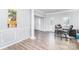Open-concept living room with wood-look floors, decorative columns and sunlit windows at 407 Goodloe Dr, Charlotte, NC 28262