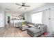 Open-concept living room featuring plush seating, hardwood floors, and view to the kitchen at 407 Goodloe Dr, Charlotte, NC 28262