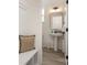 Clean and simple powder room with pedestal sink, large mirror, and neutral color palette at 5120 Izzo Ln, Charlotte, NC 28214