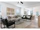 Bright, modern living room featuring hardwood floors, contemporary furnishings and an open concept dining area at 5120 Izzo Ln, Charlotte, NC 28214