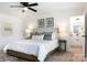 Serene main bedroom with king bed, bedside tables, lamps, and en-suite bathroom access at 5120 Izzo Ln, Charlotte, NC 28214