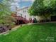 Green backyard featuring a wooden back deck with staircase at 5412 Crosshill Ct, Charlotte, NC 28277