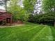 Spacious backyard with manicured lawn and mature trees at 5412 Crosshill Ct, Charlotte, NC 28277