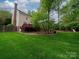 Well-maintained backyard featuring green lawn, wooden fence and a back deck at 5412 Crosshill Ct, Charlotte, NC 28277