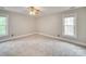 Carpeted bedroom featuring a ceiling fan and two windows at 5412 Crosshill Ct, Charlotte, NC 28277