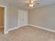 Spacious bedroom features neutral carpeting, closet, ceiling fan, and base trim at 5412 Crosshill Ct, Charlotte, NC 28277