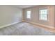Spacious carpeted bedroom with windows, base molding and neutral walls at 5412 Crosshill Ct, Charlotte, NC 28277