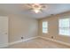 Neutral bedroom featuring a ceiling fan, two windows, and plush carpeting at 5412 Crosshill Ct, Charlotte, NC 28277