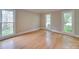 Bright bedroom with hardwood floors, neutral walls, and multiple windows providing ample natural light at 5412 Crosshill Ct, Charlotte, NC 28277