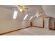 Spacious carpeted room with bright skylights and view to another room at 5412 Crosshill Ct, Charlotte, NC 28277