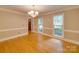 Elegant dining room with hardwood floors, neutral walls, chandelier, and natural light at 5412 Crosshill Ct, Charlotte, NC 28277