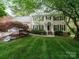 Charming two-story home featuring a well-manicured lawn, mature trees, and inviting front entrance at 5412 Crosshill Ct, Charlotte, NC 28277