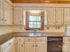 Bright kitchen showcasing custom cabinets, granite countertops, stainless steel sink, and dishwasher at 5412 Crosshill Ct, Charlotte, NC 28277