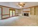 Spacious living room with fireplace, built-in bookshelves, plush carpeting and large windows at 5412 Crosshill Ct, Charlotte, NC 28277